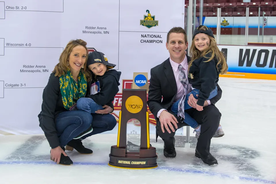 Shannon Desrosiers, husband Matt Desrosiers and their two children pose with Clarkson's national championship trophy. (Provided by Desrosiers)